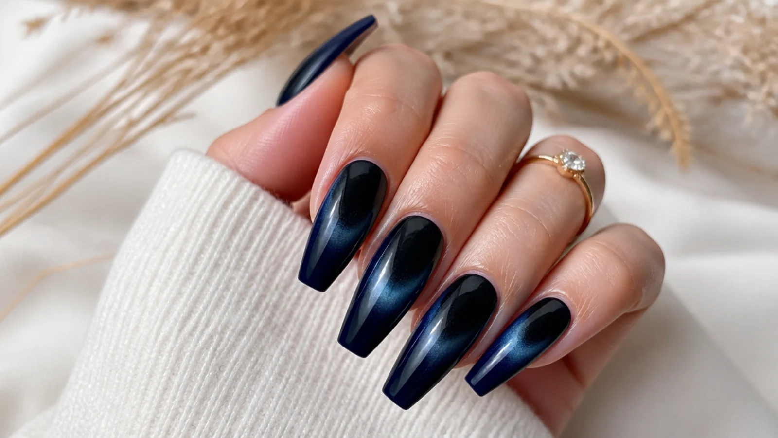 Navy blue aura nails with a near black center glow on long coffin shaped nails