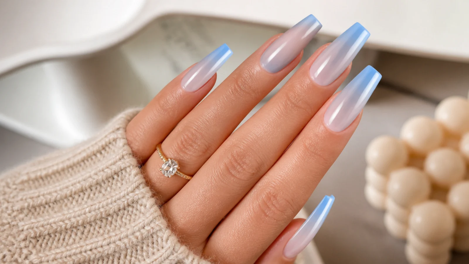Long coffin blue aura nails with a stretched blue halo running down the tapered nail