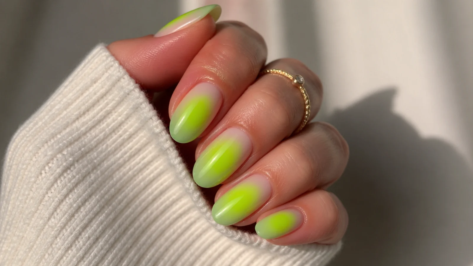 Lime green aura nails with a bright yellow-green halo glowing through a translucent base