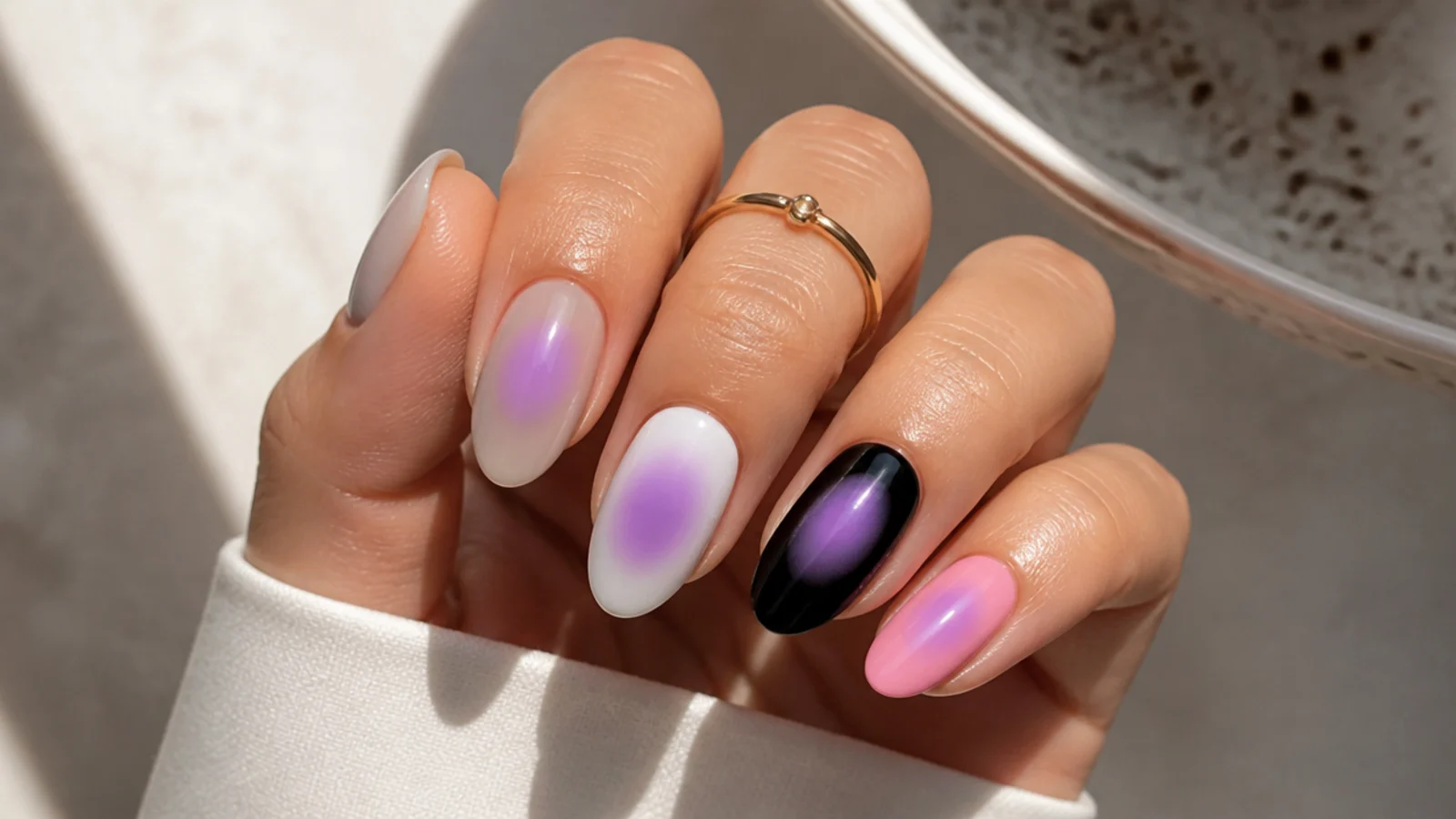 The same lilac aura halo shown over sheer nude, milky white, black and opaque pink bases