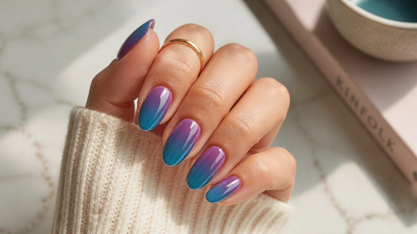 Almond nails with a violet aura at the cuticle blending into teal at the tip