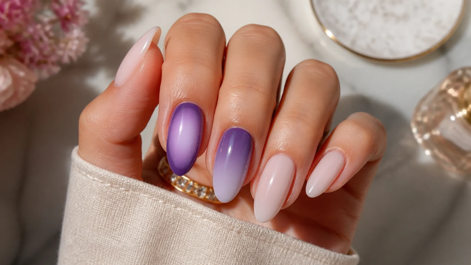 Two purple nails compared, one with a centered aura halo and one with a cuticle-to-tip ombre fade