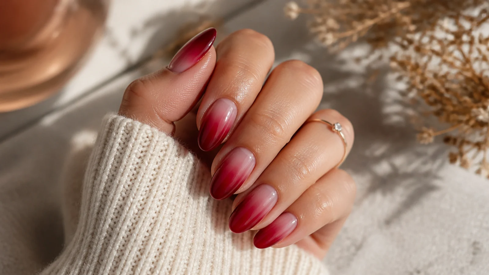 Medium almond red aura nails with an oval red glow following the tapered nail shape