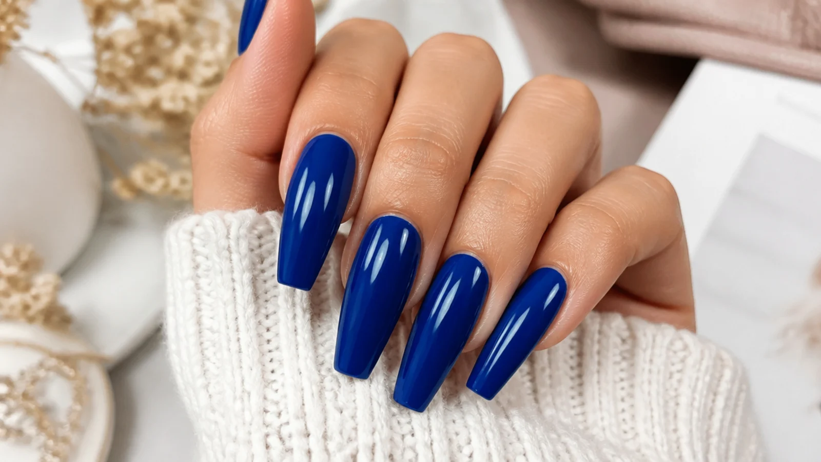 Vivid royal blue coffin nails with a glossy finish on long tapered tips