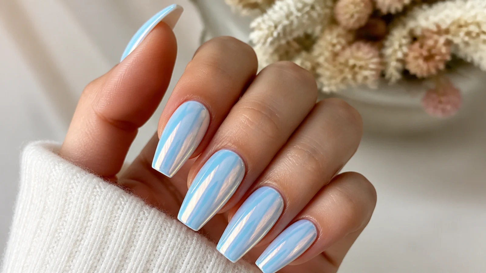 Light blue chrome coffin nails with a frosted pearl mirror finish