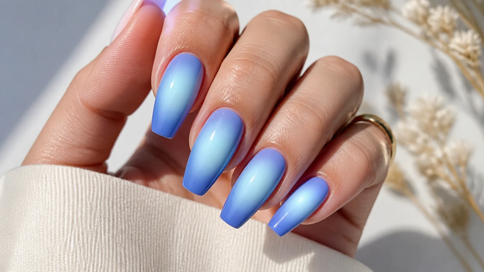 Blue aura coffin nails with an airbrushed glowing halo at the center