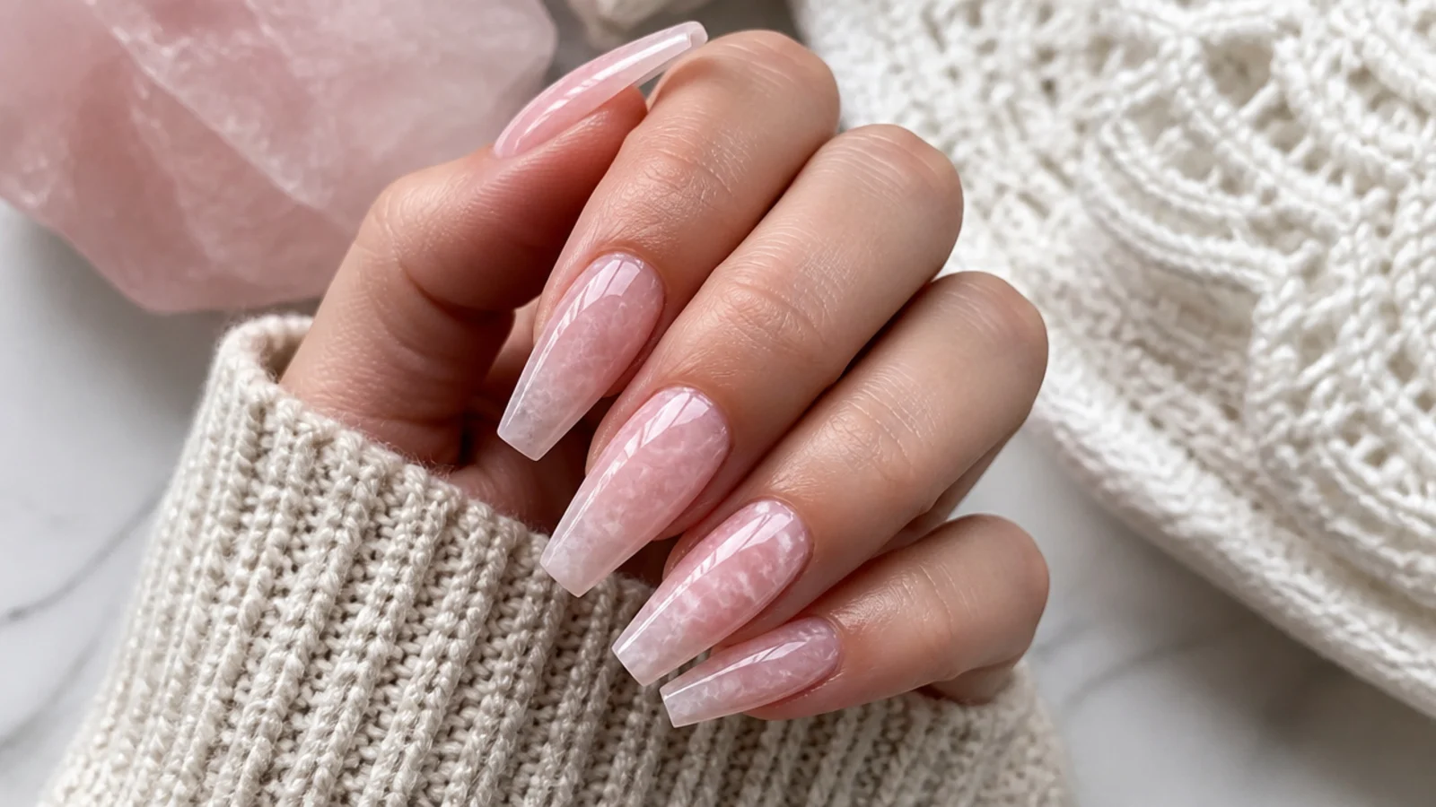 Coffin nails with a rose quartz stone effect in translucent pink with white veining