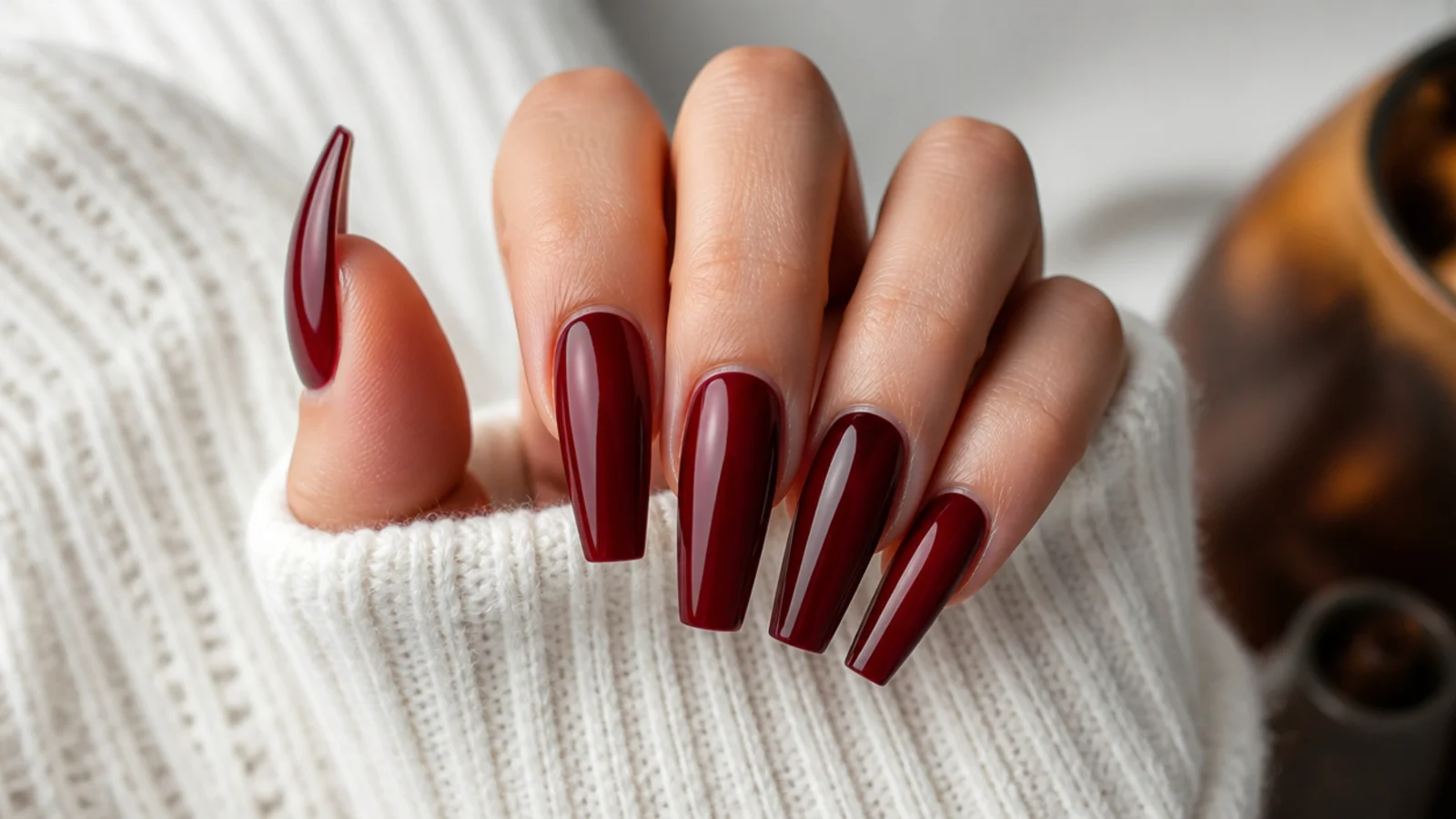 Long cherry red coffin nails with a deep glossy finish and tapered sidewalls
