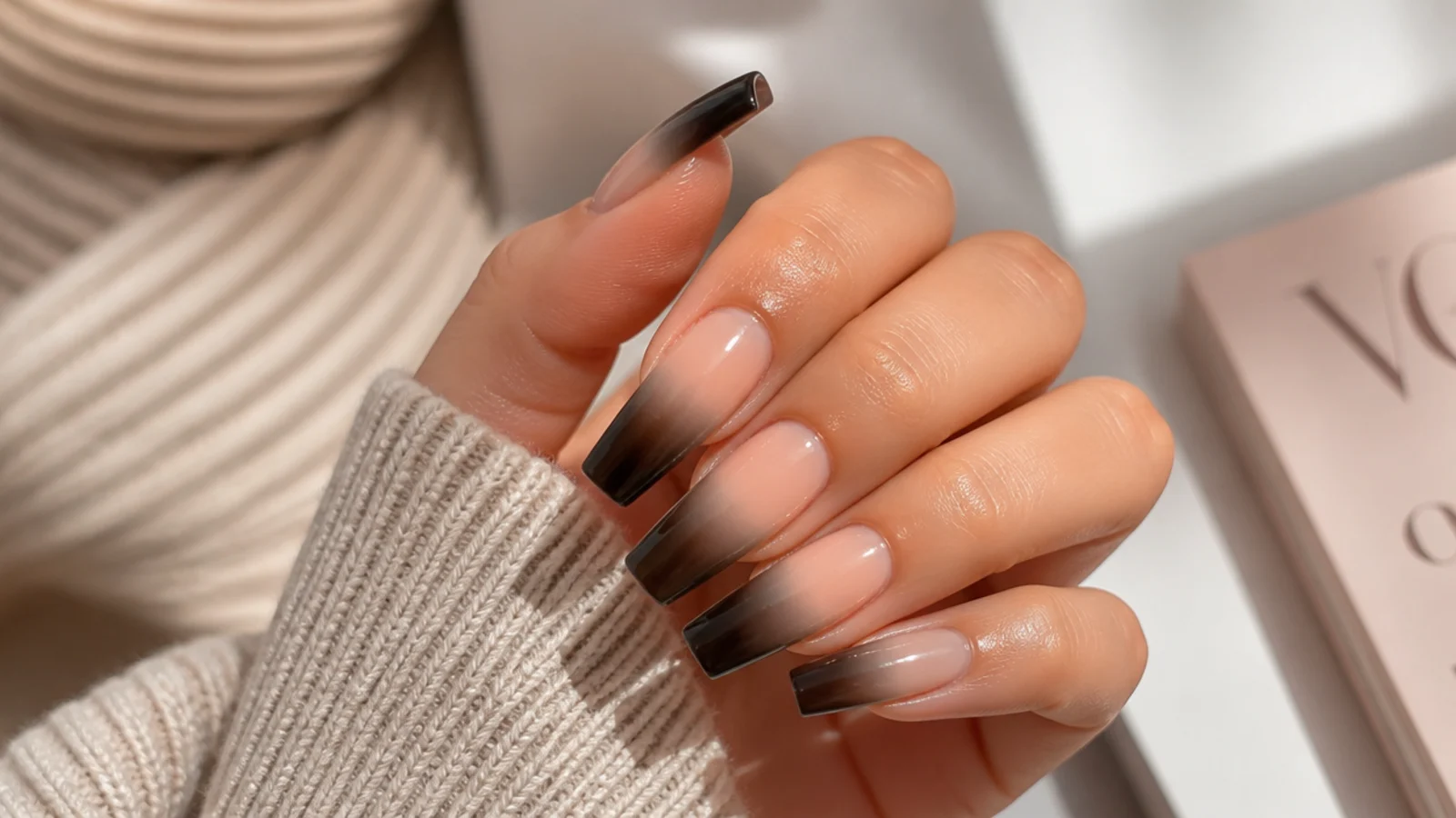 Coffin nails with a smoky black French tip fading into a sheer nude base
