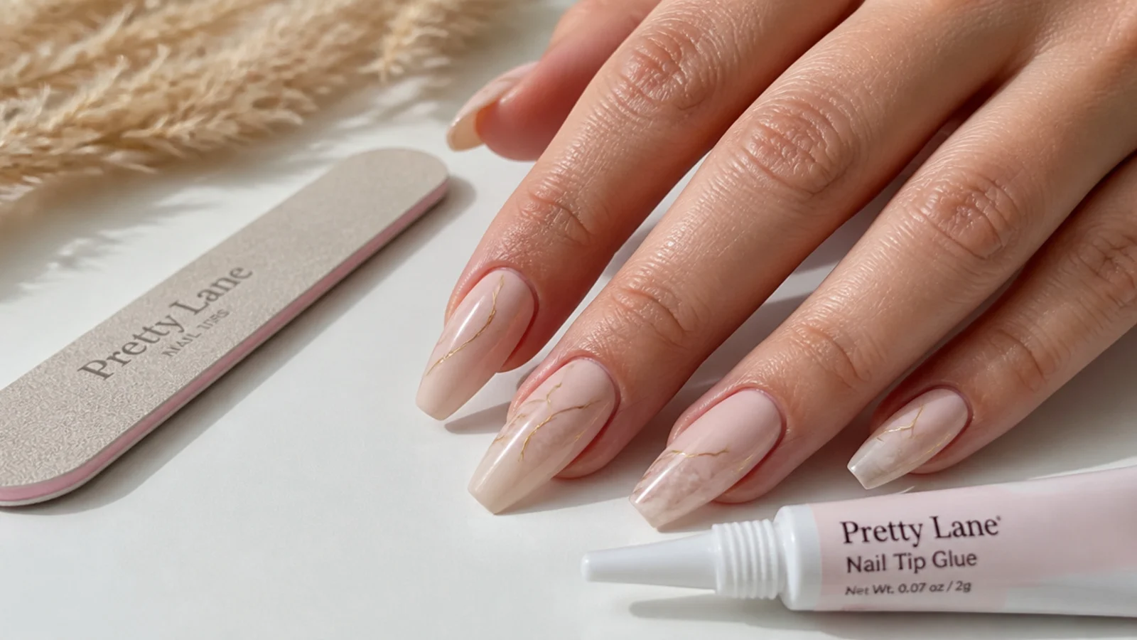 Medium coffin artificial nail tips with a file and glue tube on a white surface