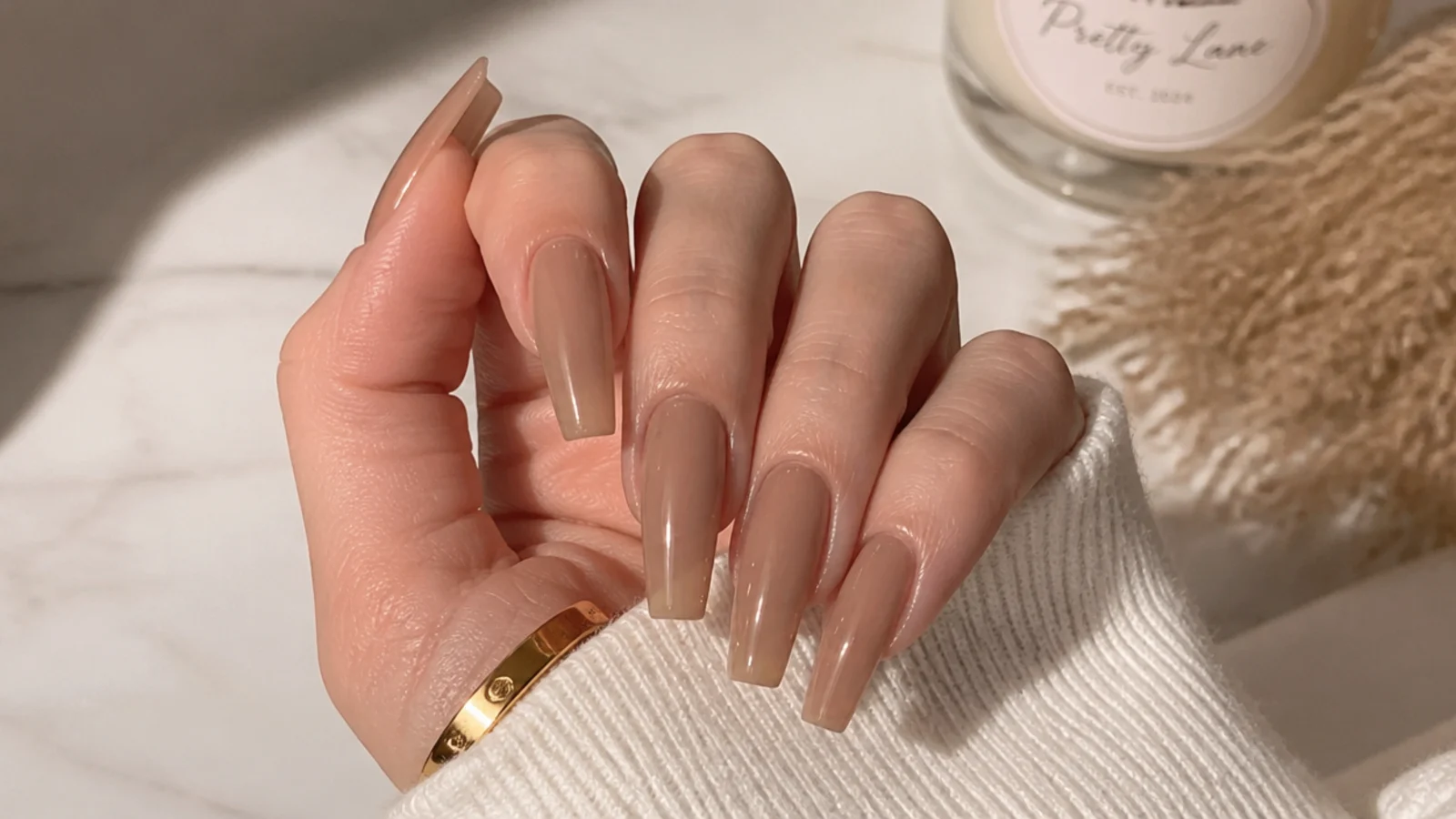 Sheer milky mocha coffin nails showing the natural nail through a translucent brown