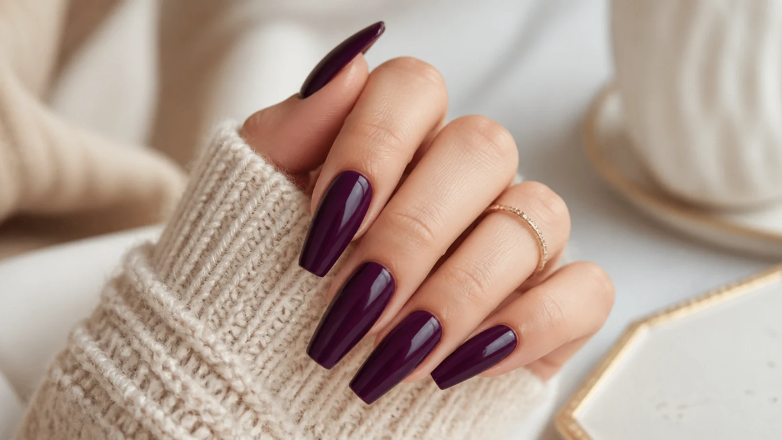 Deep plum purple coffin nails with a rich glossy vampy finish