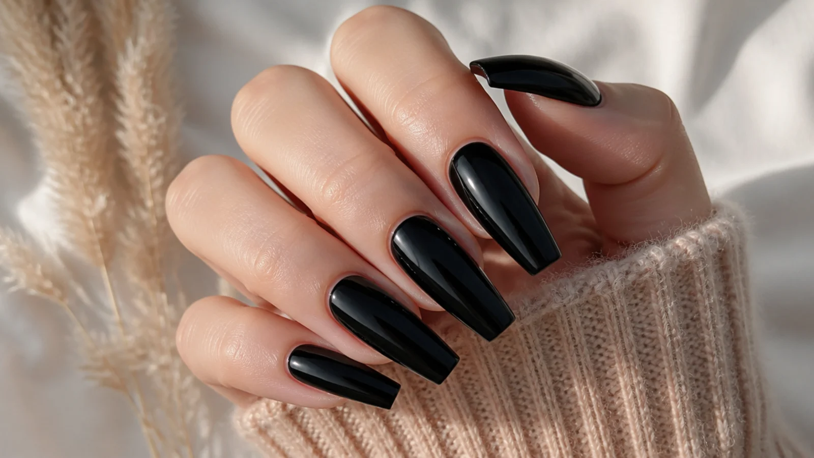 Long glossy black coffin nails with a sharp tapered flat tip