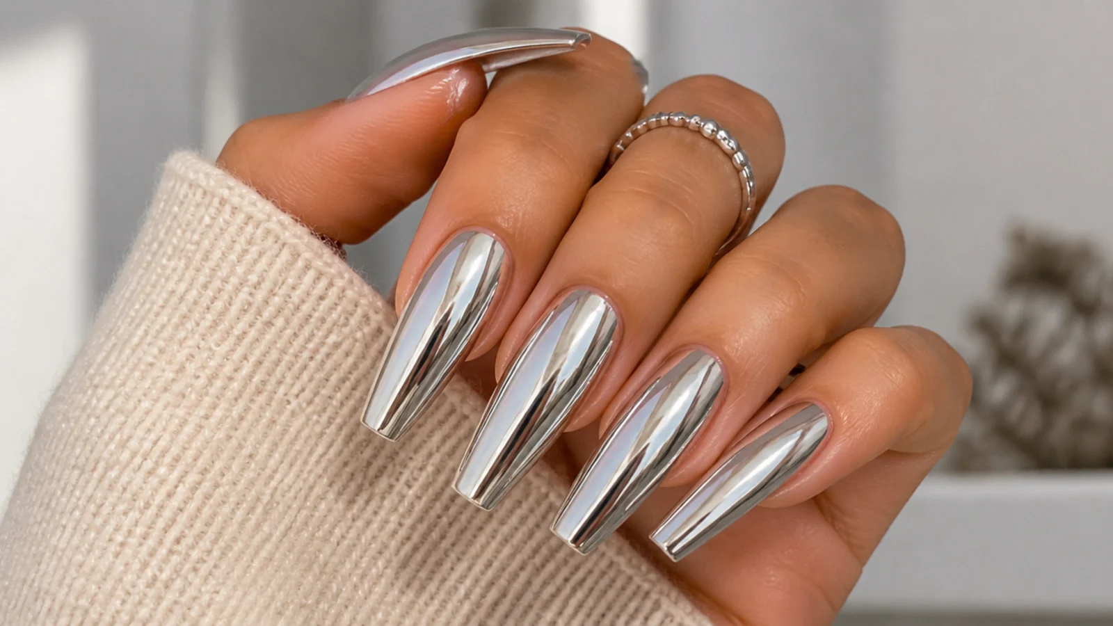 Long chrome coffin nails with a mirror metallic finish on extended acrylic