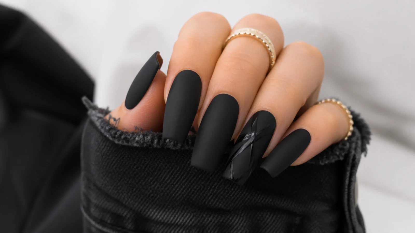 Long coffin nails in matte black with glossy black detail lines on one nail