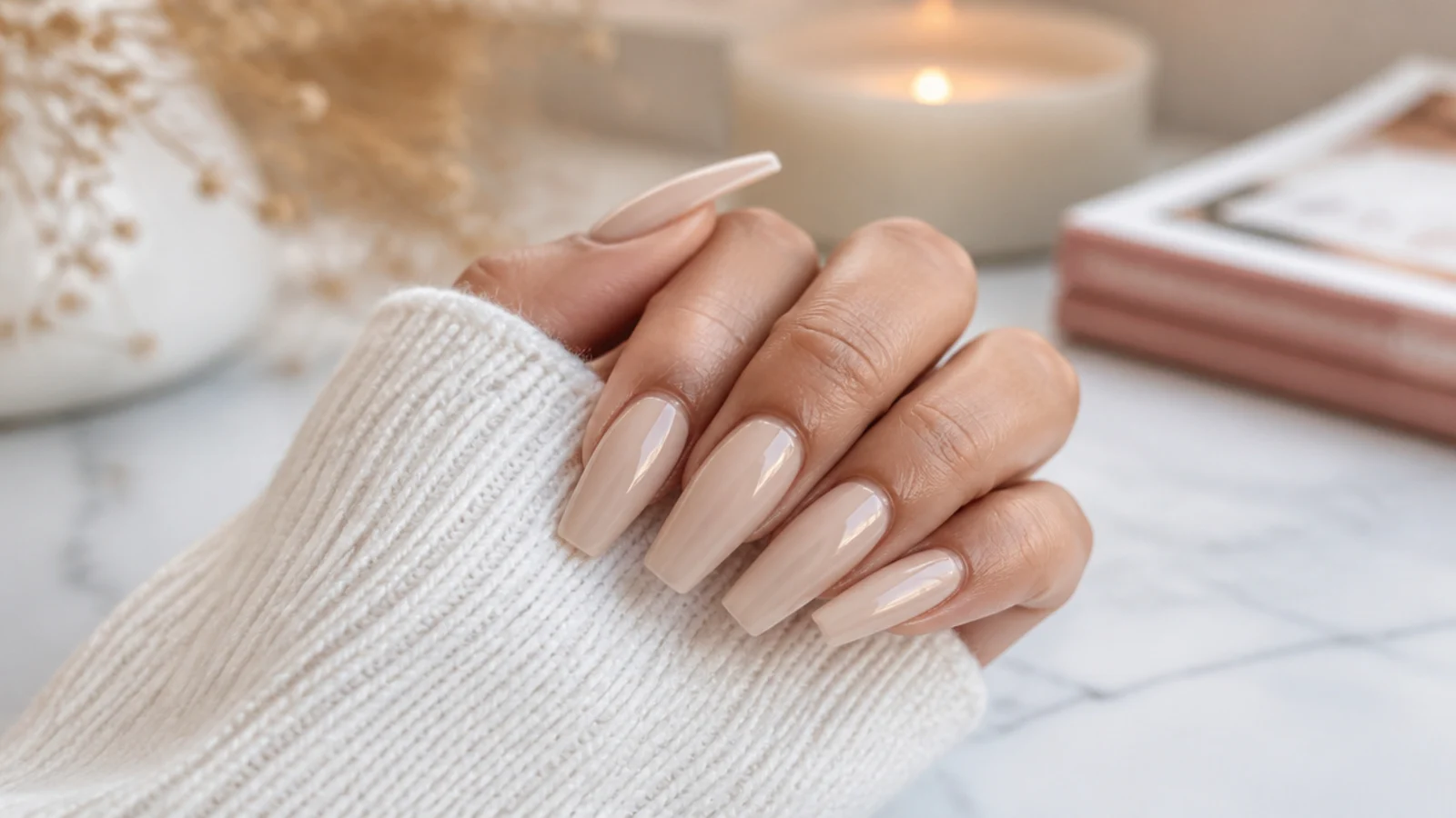 Long coffin nails in glossy nude with a tapered flat tip on an extended acrylic set