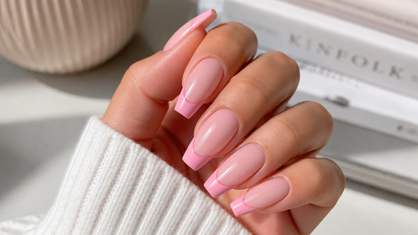 Pink french coffin nails with a bubblegum pink smile line on a sheer base