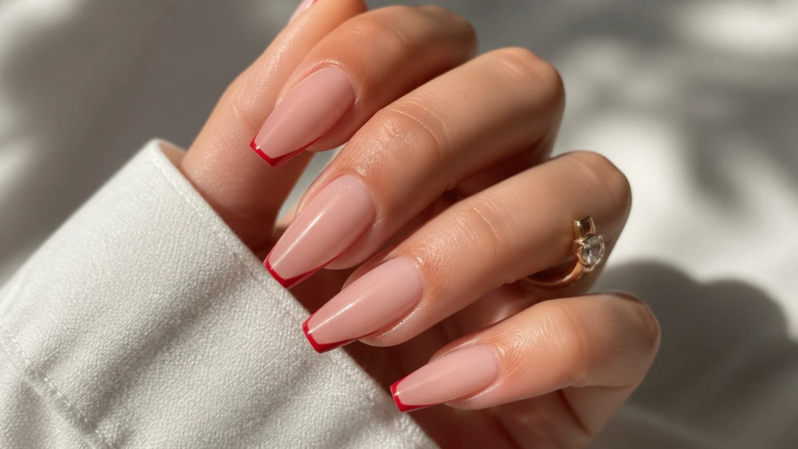 Coffin nails with a hairline red micro French tip on a bare natural base