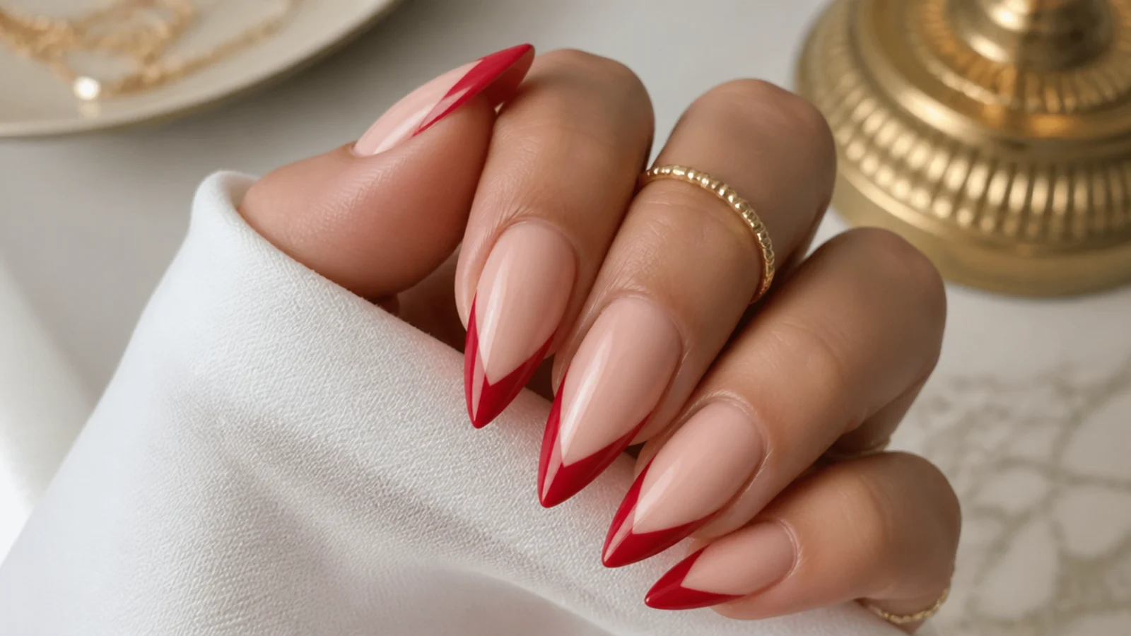 Coffin nails with a pointed red V-shaped French tip on a nude base