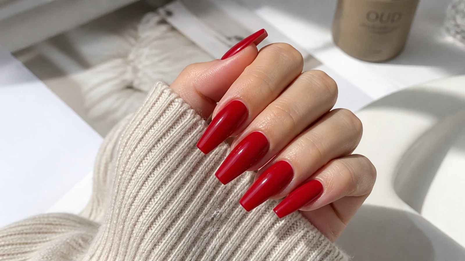 Glossy cherry red coffin nails with a flat tapered tip on medium length