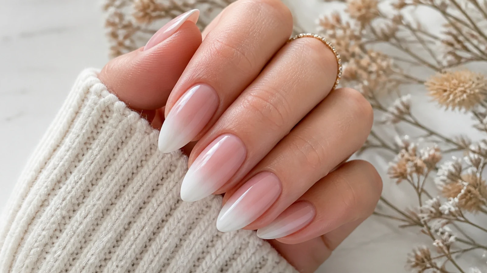 Almond acrylic nails fading from soft pink at the cuticle into a soft white tip