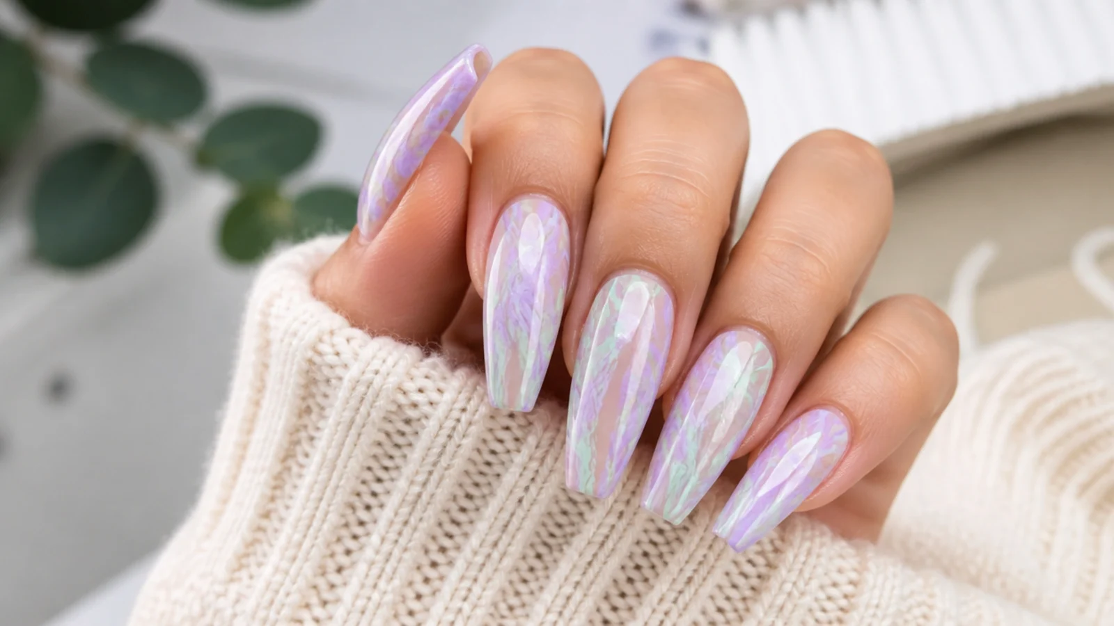 Coffin acrylic nails with swirled lavender and mint green marble veining under gloss