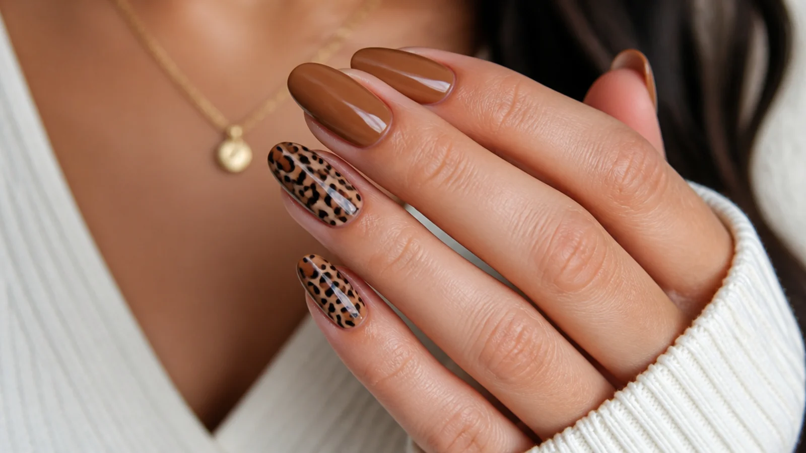 Medium almond acrylic nails in caramel with brown and black leopard print on two accent nails