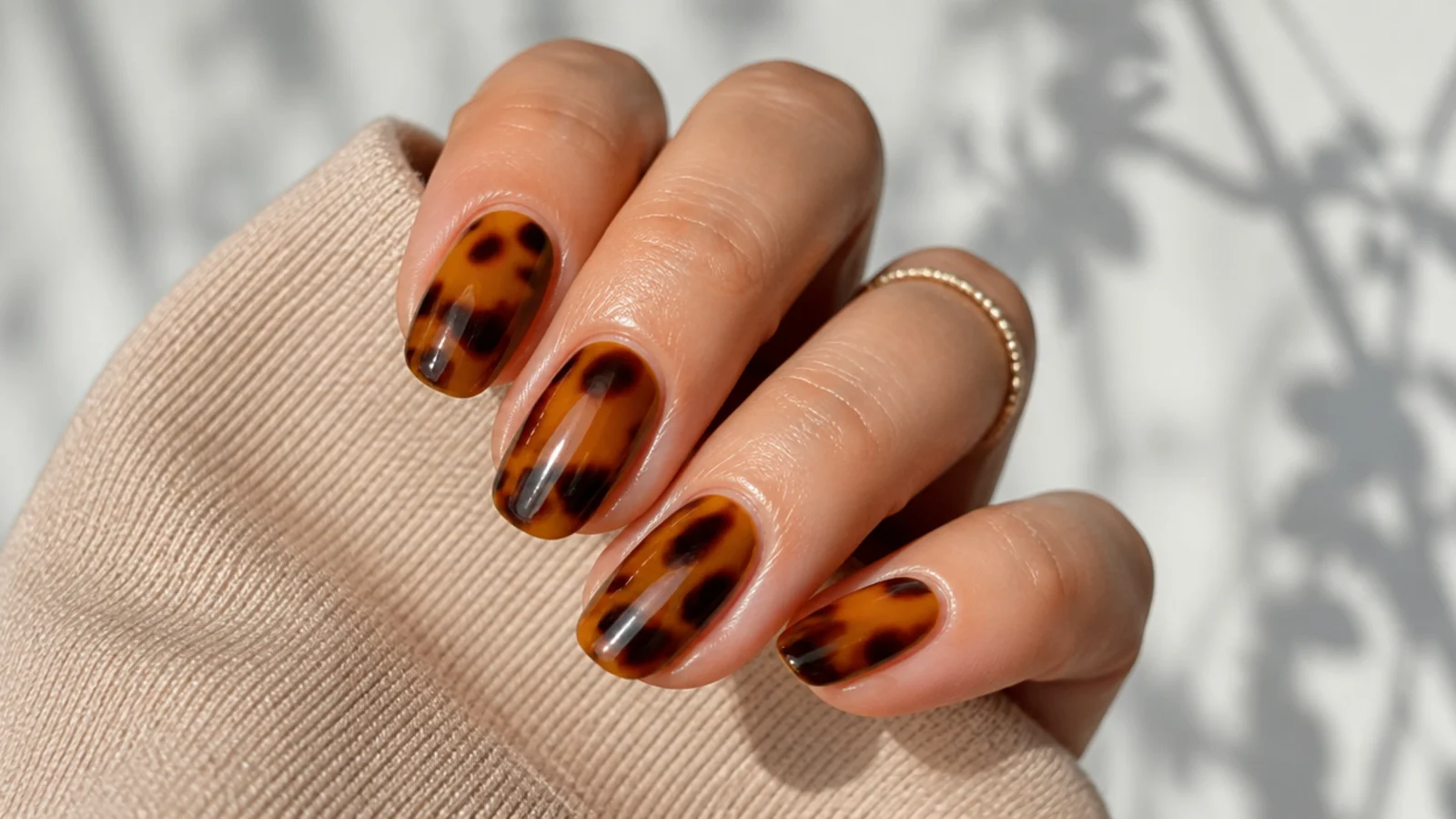 Amber and dark brown mottled tortoiseshell nails over a honey base