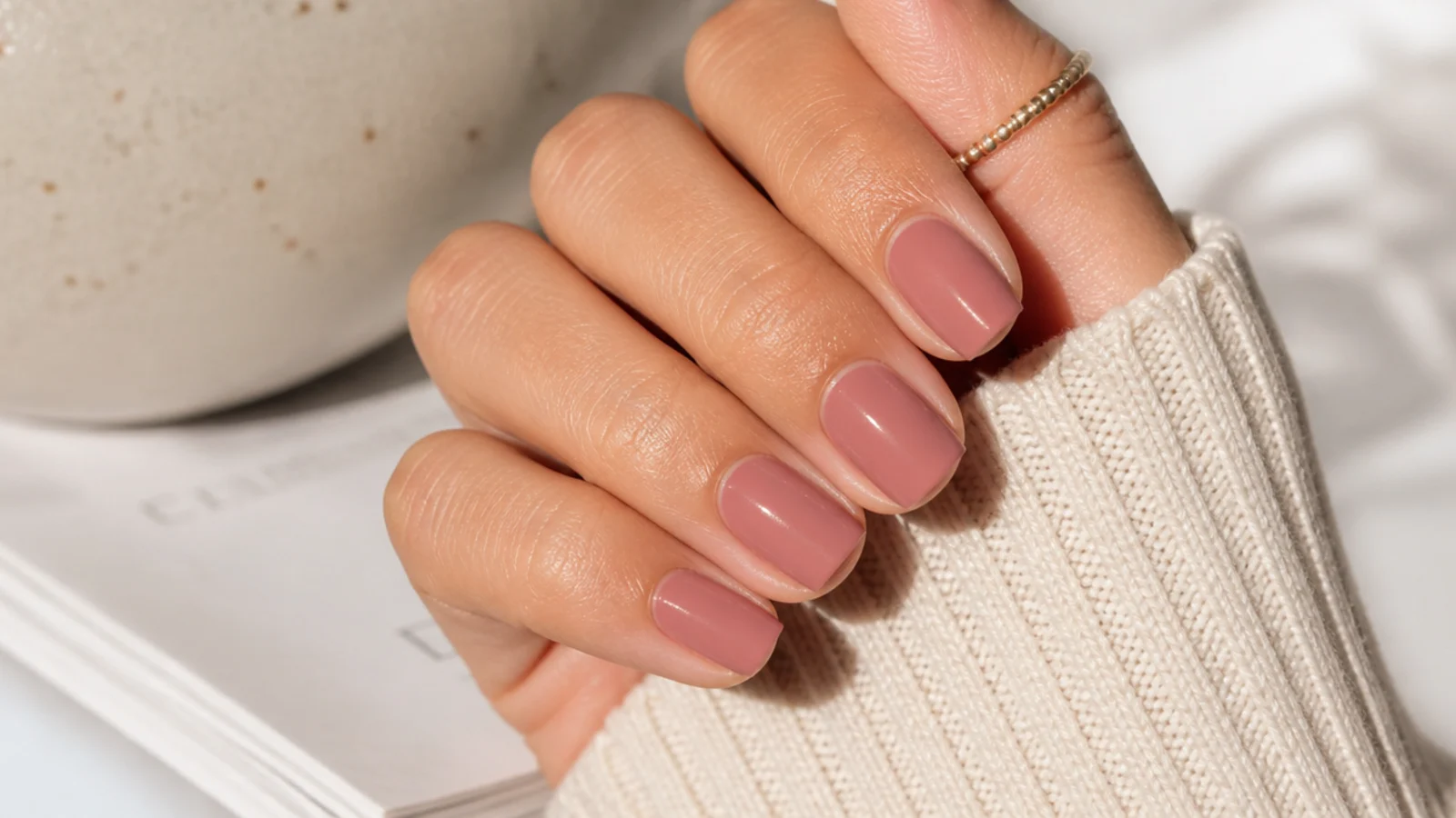 Short squoval nails in muted dusty rose pink with a soft satin finish