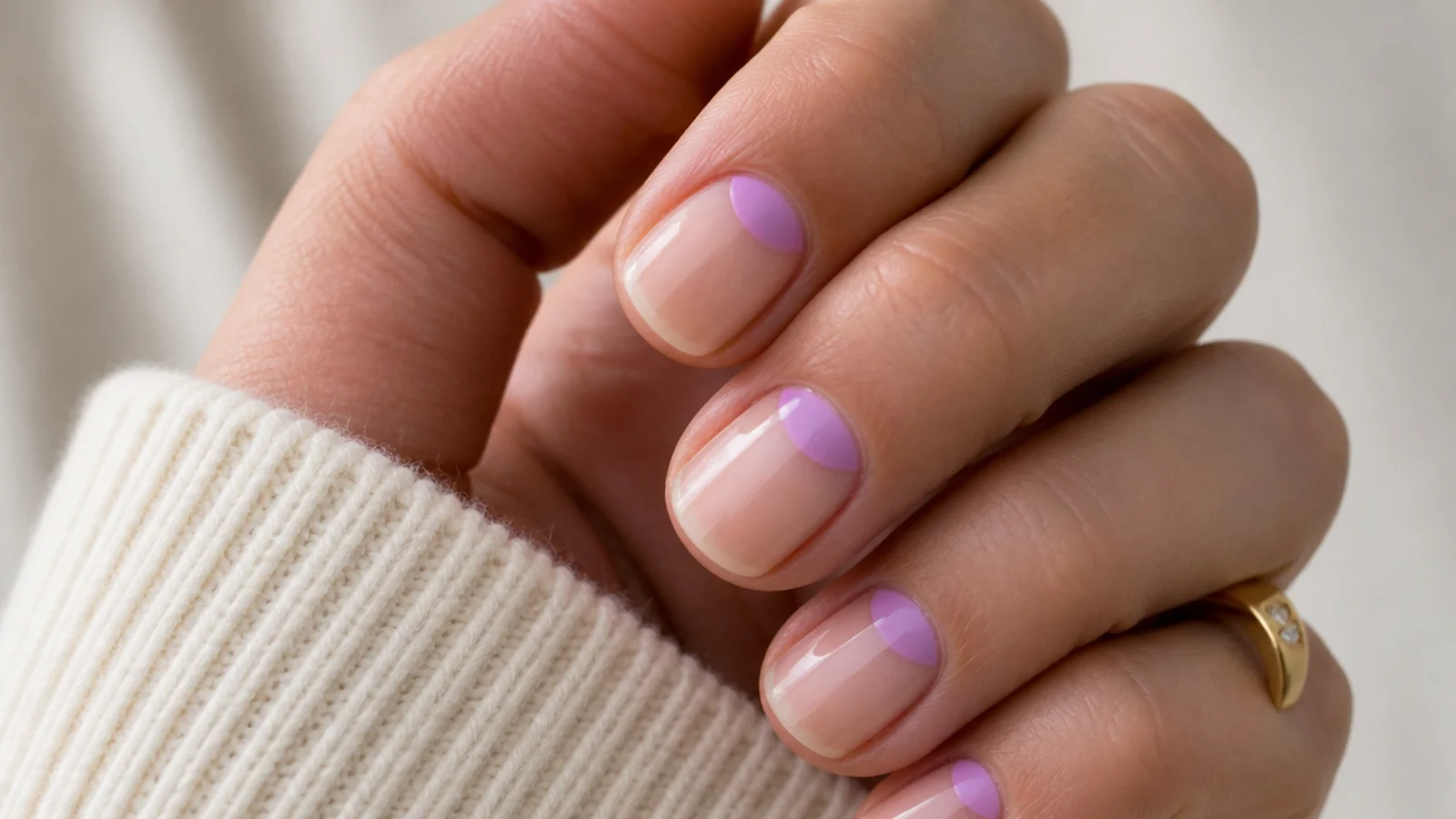 Short nails with a reverse French band of lilac color at the cuticle and a bare tip