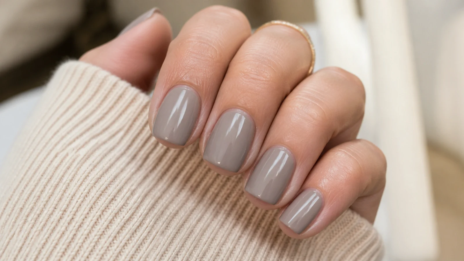 Short squoval nails in gray-beige greige with a flat straight tip and softly curved sidewalls