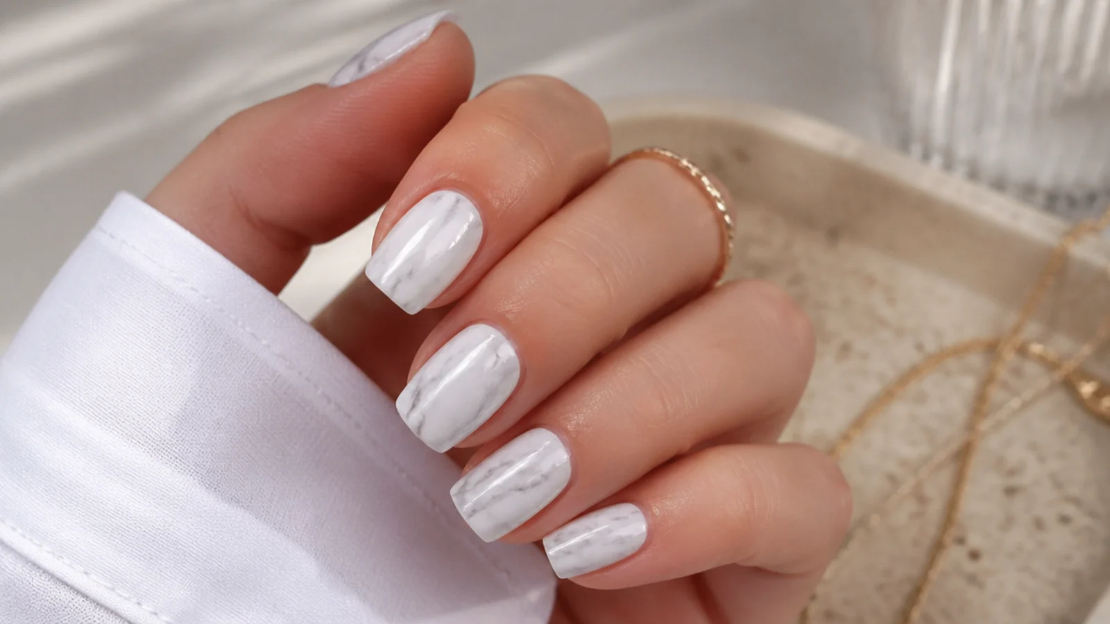 White nails with soft gray marble veining dragged through wet polish with a toothpick