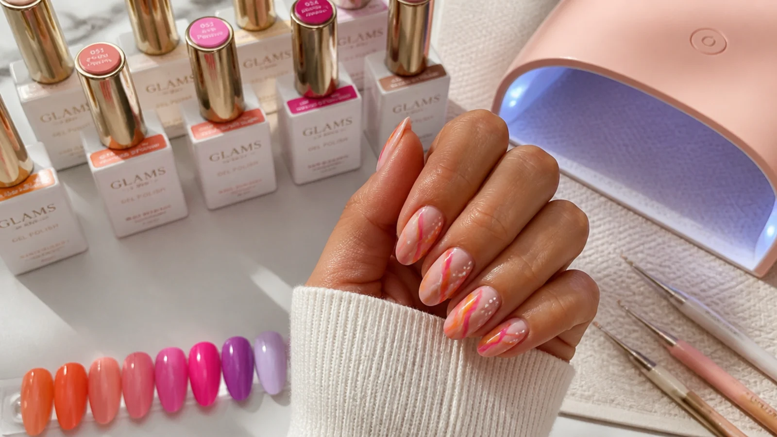Nail salon station with bright summer gel polish bottles, lamp and dotting tools laid out