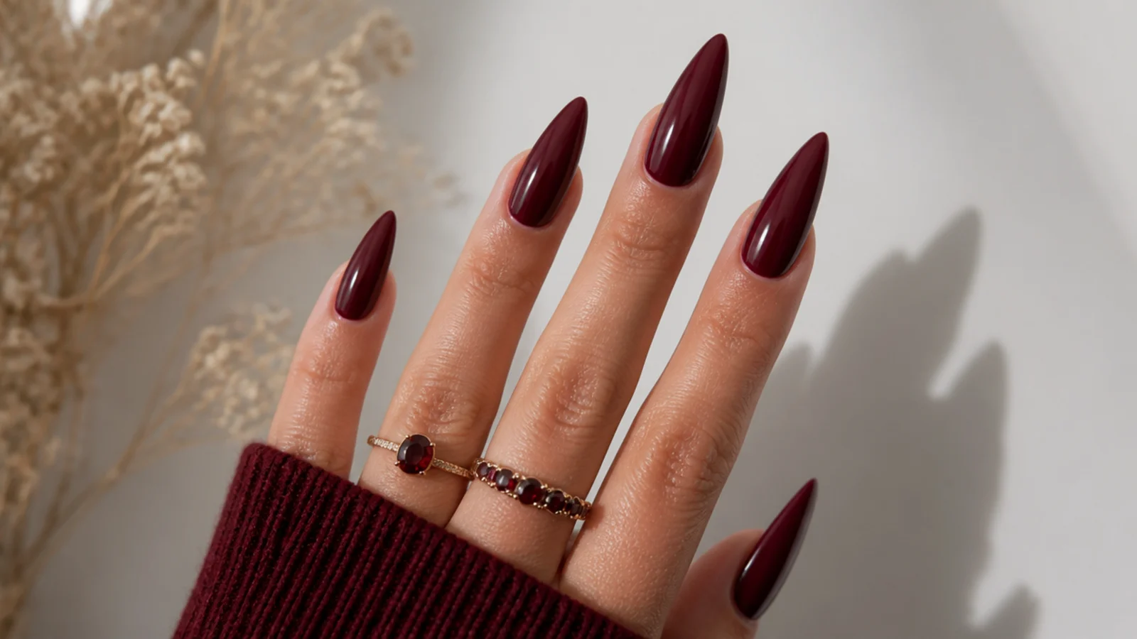 Deep wine red stiletto acrylic nails with sharp points
