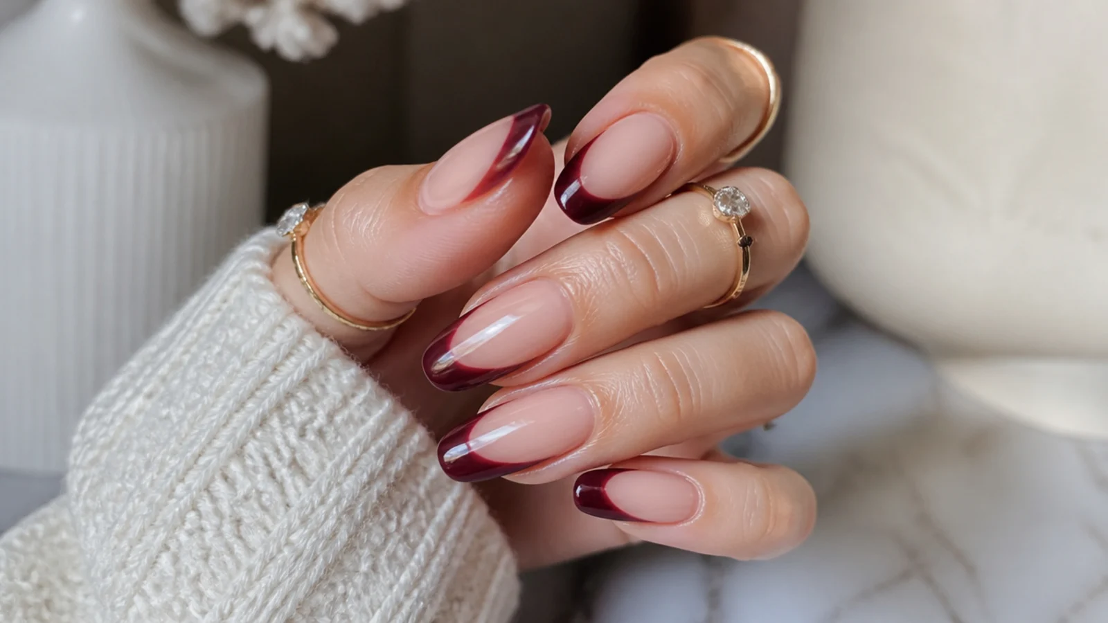Nude almond acrylic nails with deep black cherry French tips