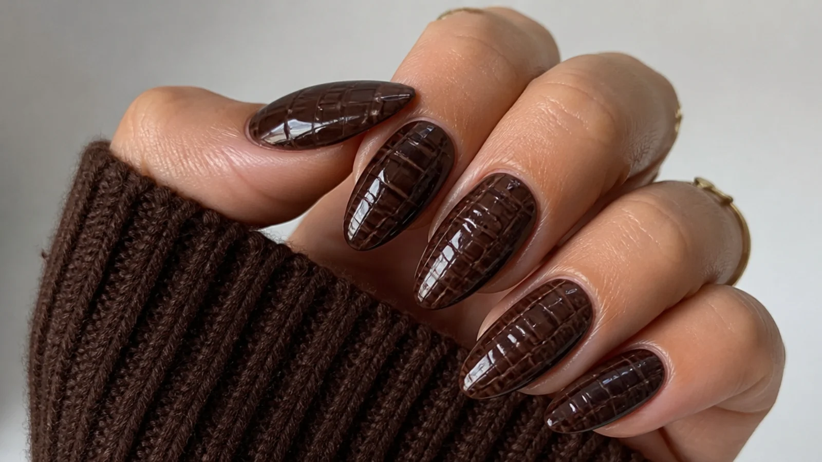 Chocolate brown almond acrylic nails with subtle 3D croc texture