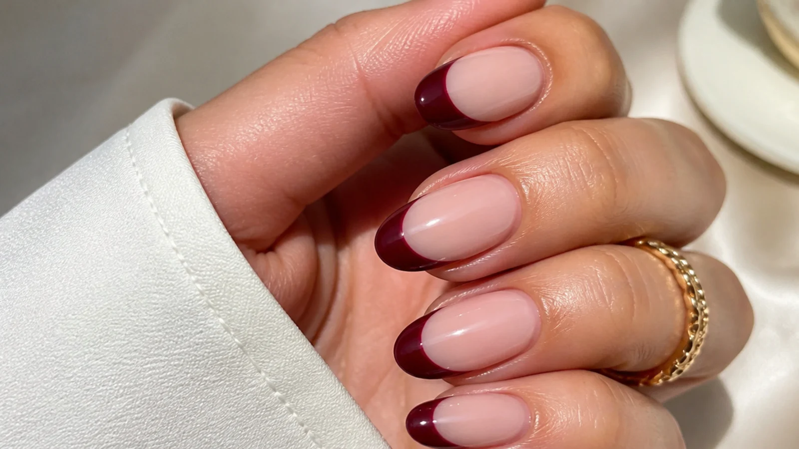 Sheer nude base with a deep mauve French tip dark feminine nails