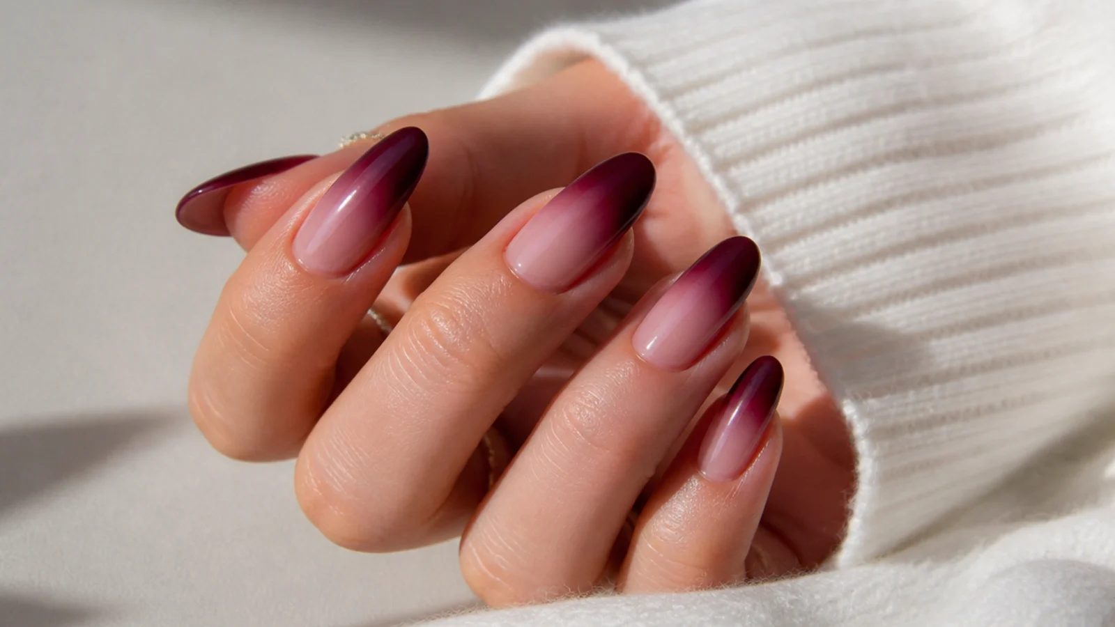Berry to nude ombre dark feminine nails fading from deep tip to bare base