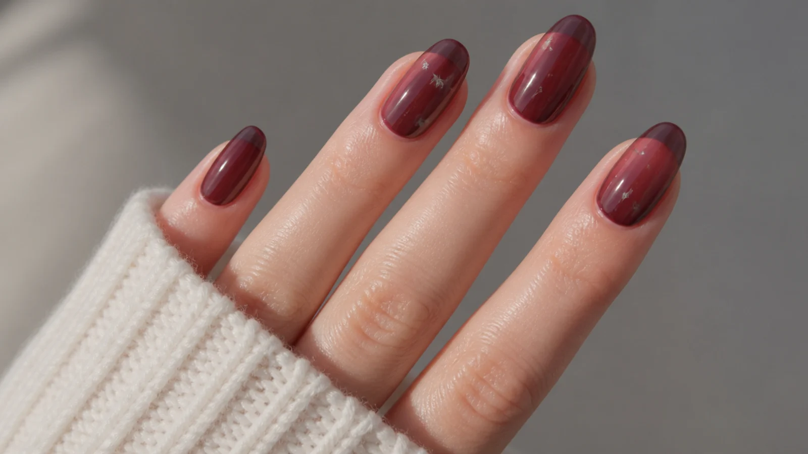 Sheer jelly berry dark feminine nails with a glassy translucent finish