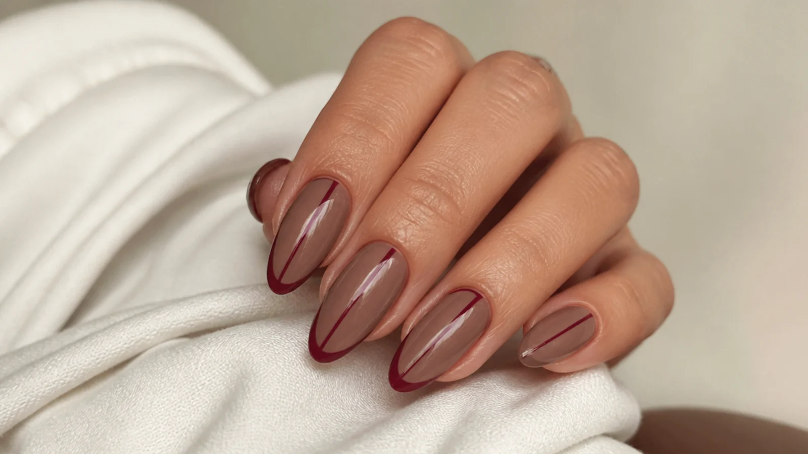 Nude dark feminine nails with a single deep mauve negative-space line