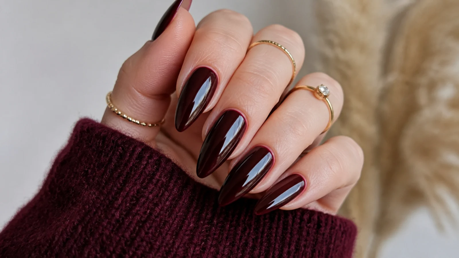 Glossy deep burgundy stiletto dark feminine nails with a glass shine