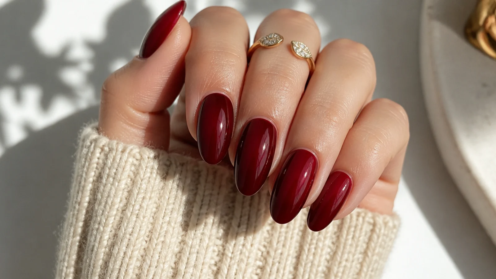Deep garnet red glossy dark feminine nails with a jewel-like shine