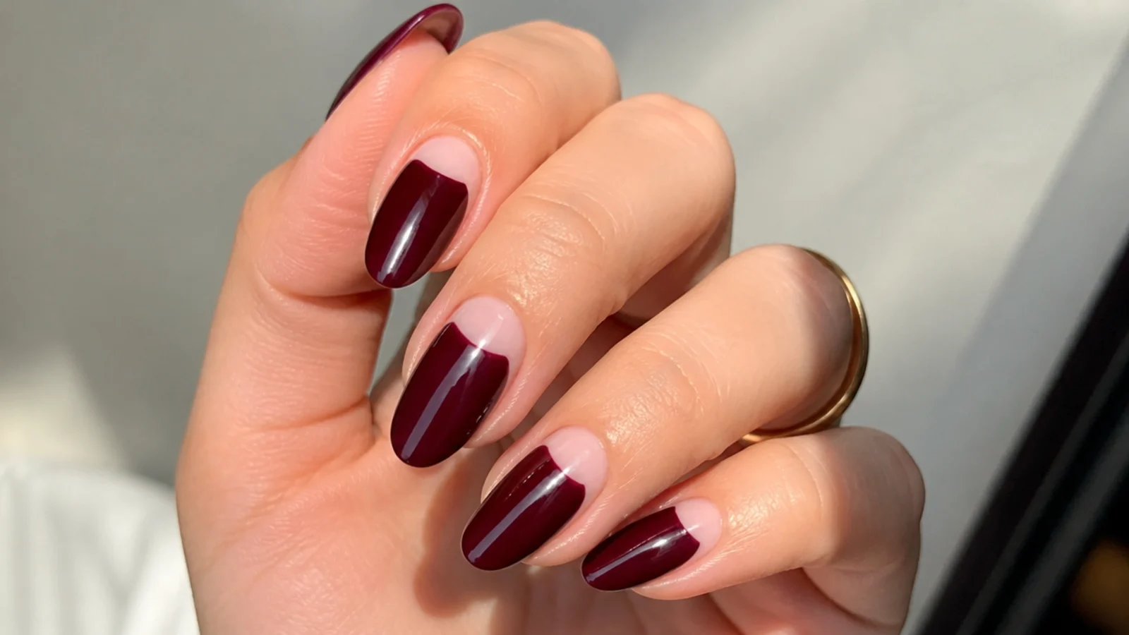 Oxblood almond nails with negative space along the cuticle