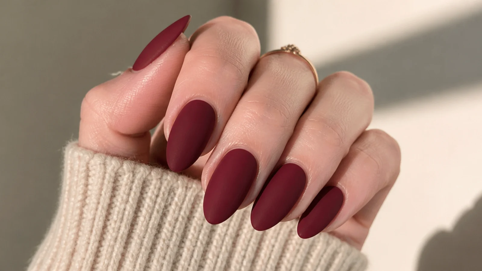 Matte wine red almond nails with a soft velvet finish