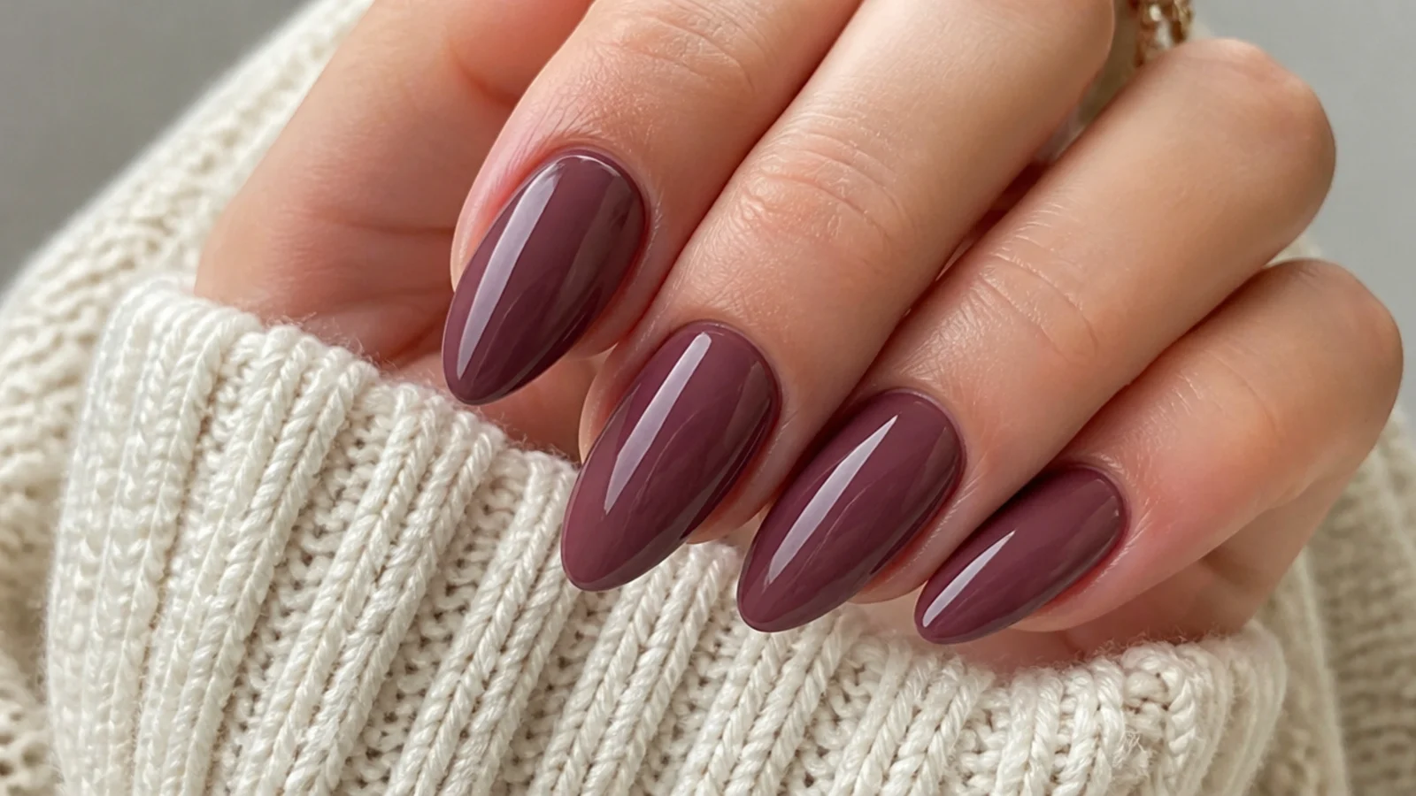 Dusty moody mauve almond nails with a glossy finish