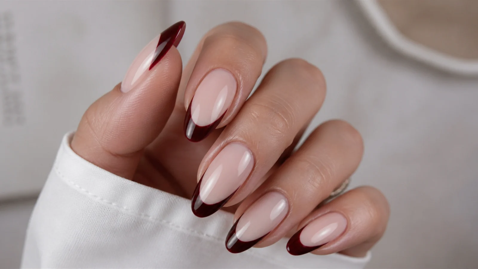 Nude almond nails with deep wine French tips