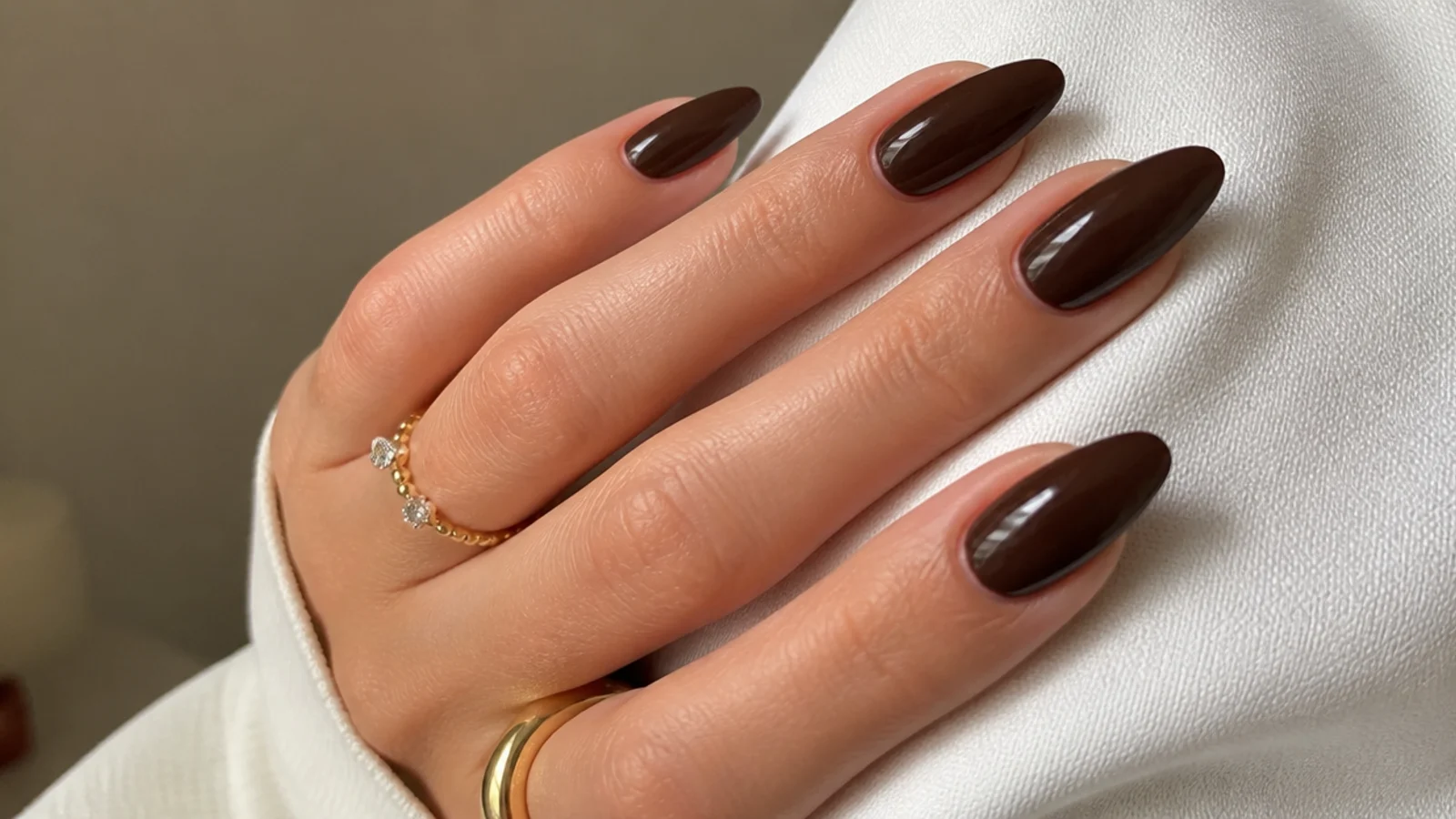 Glossy chocolate brown almond nails with a warm espresso tone