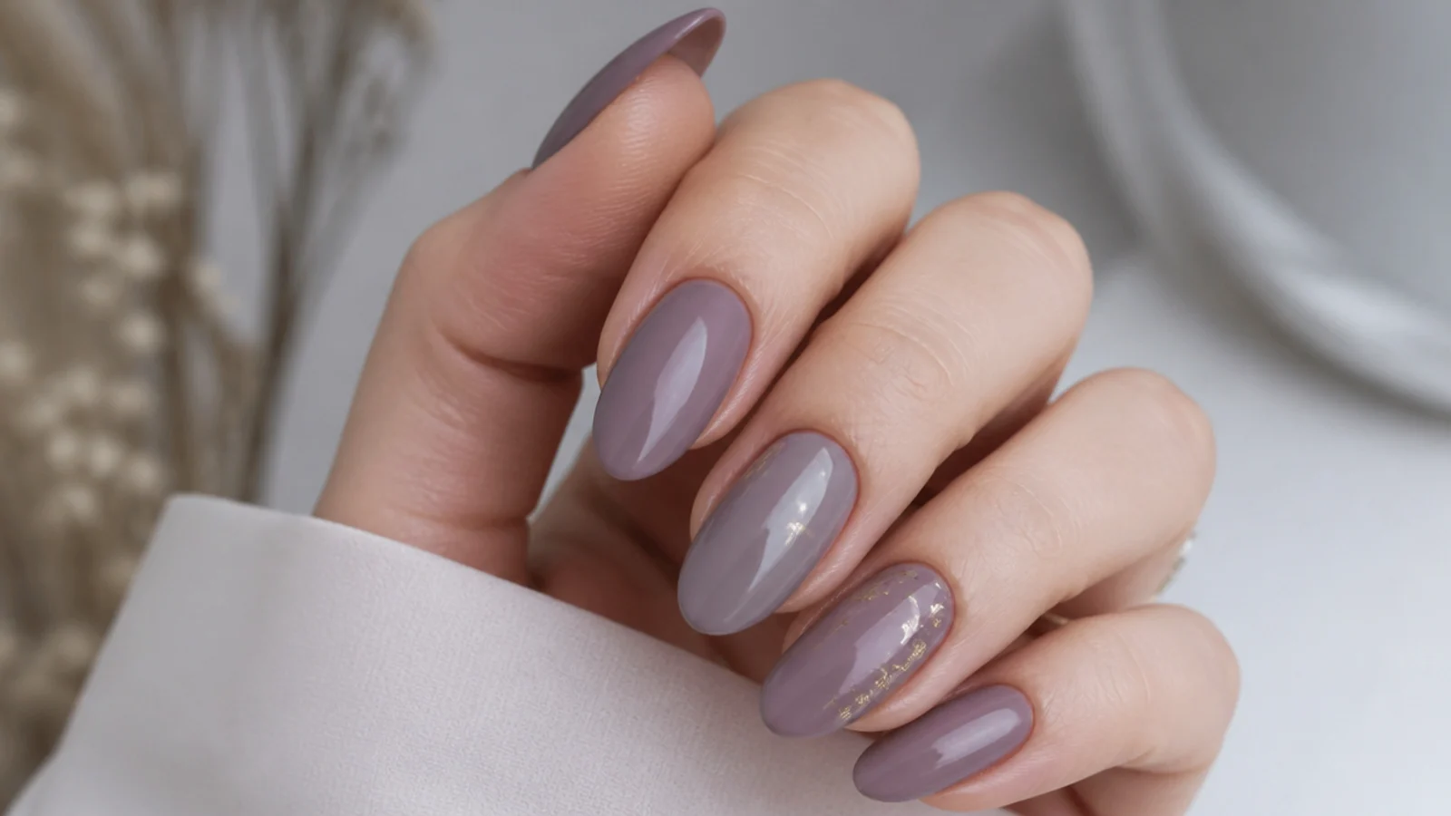 Soft milky moody mauve almond nails with a muted grayed-purple tone