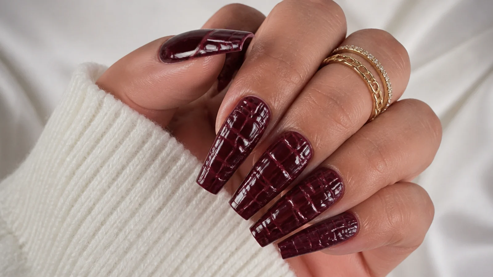 Deep wine coffin nails with a raised croc-skin textured pattern