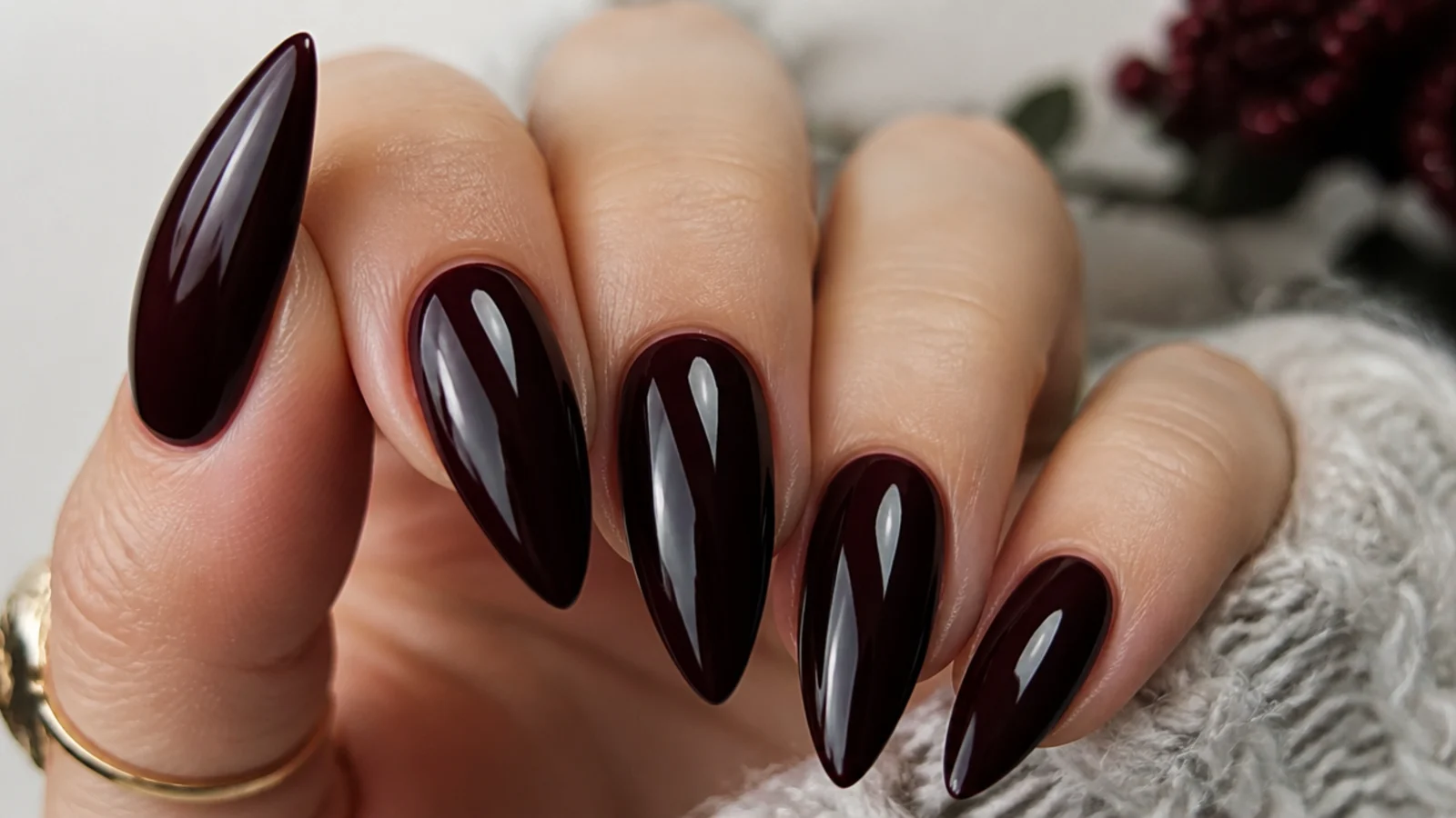 Very deep black cherry stiletto nails with a high-gloss finish